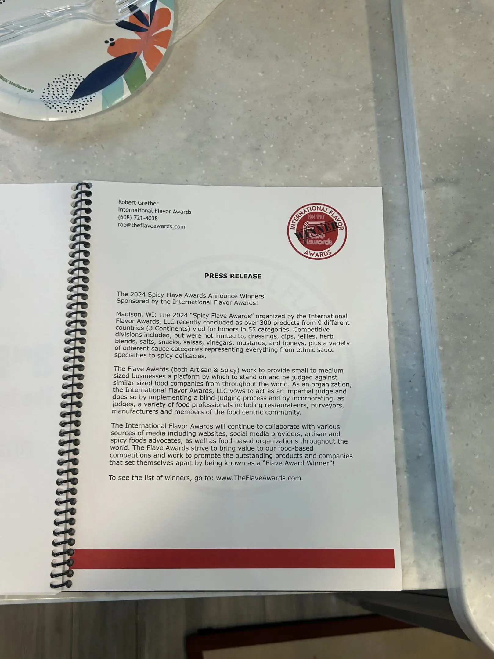 Spiral-bound press release on countertop