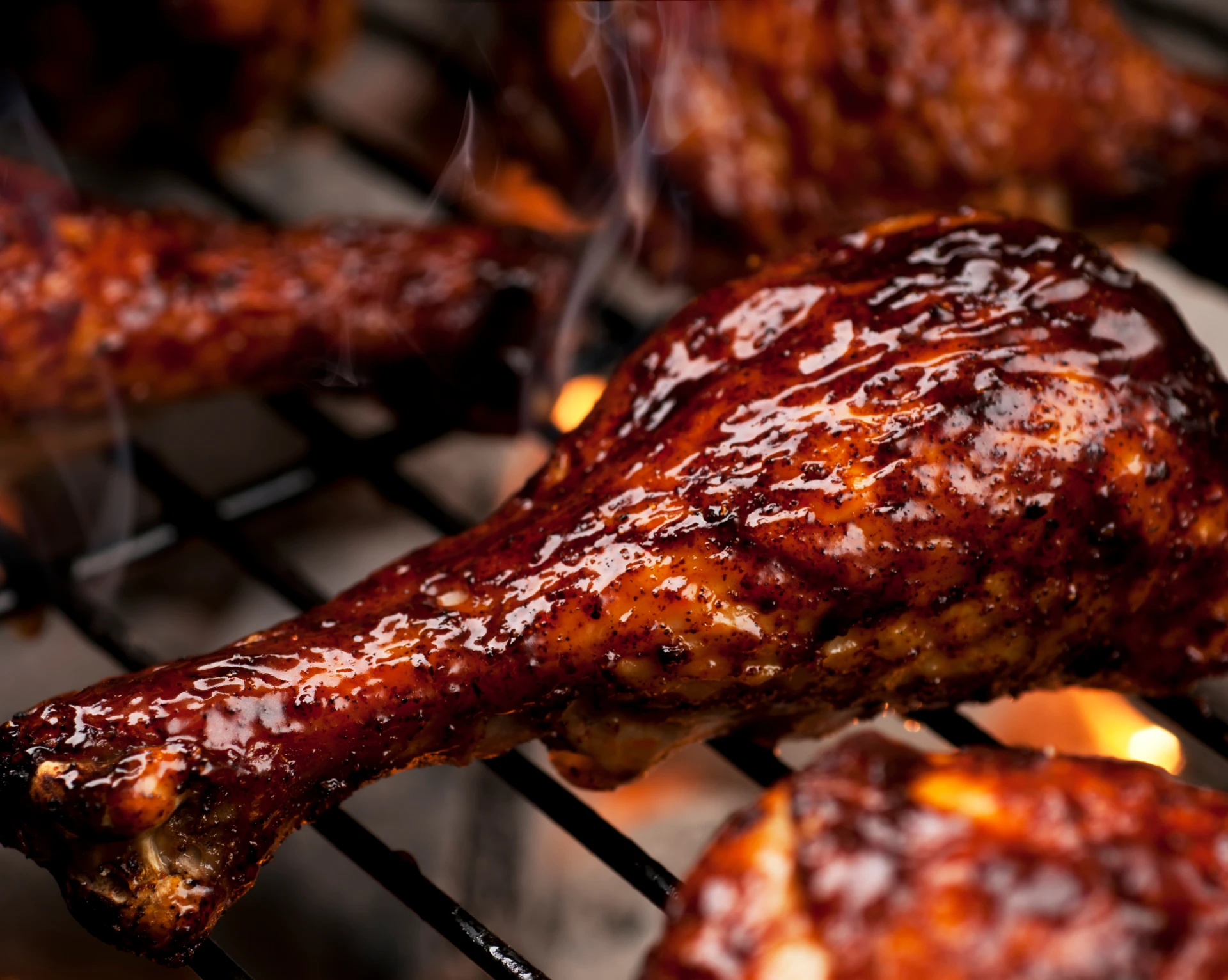 Close-up of barbecued chicken leg on grill